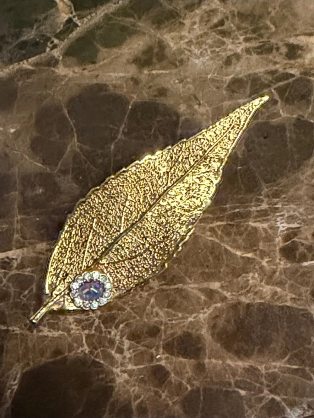 Beautiful gold plated leaf with a cabochon opal and crystal surrounding